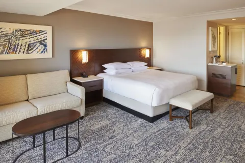 King-bed resort-view room with sofa at Hilton Hawaiian Village Waikiki Beach Resort.