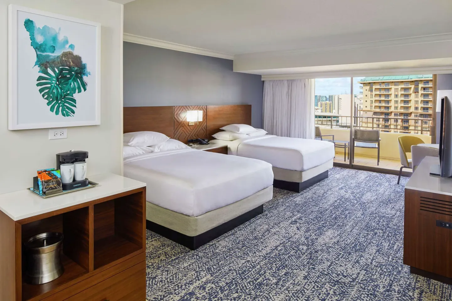 Two-bed resort-view guest room with balcony at Hilton Hawaiian Village Waikiki Beach Resort.