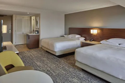 Two-bed guest room viewed from seating area at Hilton Hawaiian Village Waikiki Beach Resort.