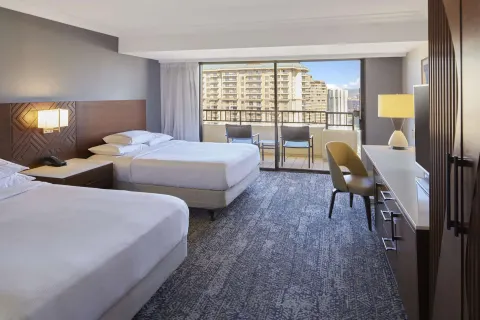 Two-bed resort-view room with balcony and desk at Hilton Hawaiian Village Waikiki Beach Resort.