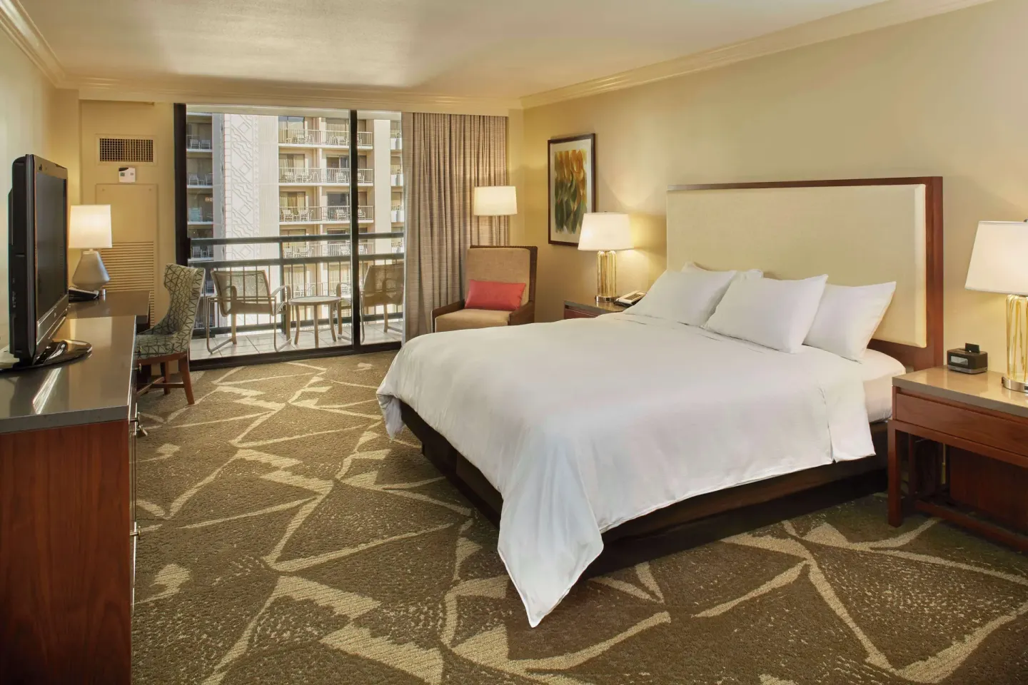 King-bed resort-view guest room with balcony at Hilton Hawaiian Village Waikiki Beach Resort.