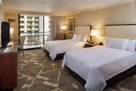 Resort view room with two beds, TV, and balcony at Hilton Hawaiian Village Waikiki Beach Resort.