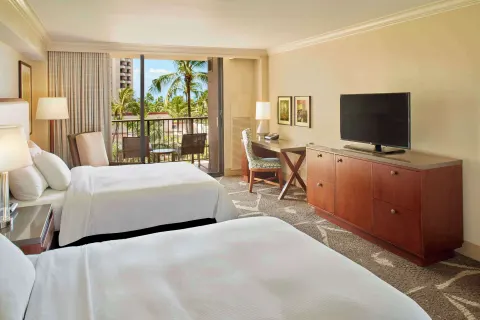 Resort view room with two beds, TV dresser, and palms outside at Hilton Hawaiian Village Waikiki Beach Resort.