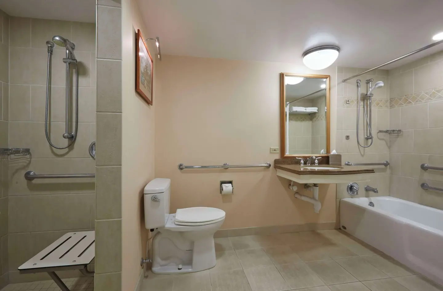 Accessible guest bathroom with roll-in shower and tub at Hilton Hawaiian Village Waikiki Beach Resort.