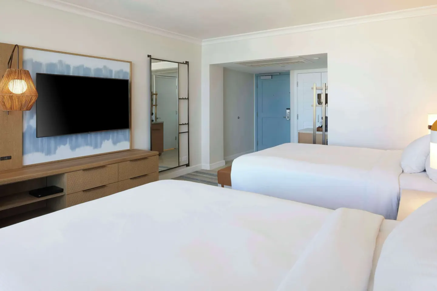 Two-bed resort-view guest room at Hilton Hawaiian Village Waikiki Beach Resort with TV and entry area.
