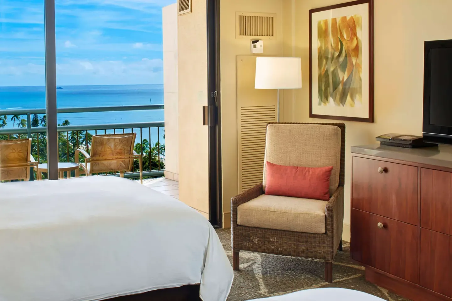 Ocean view bedroom and balcony in a suite at Hilton Hawaiian Village Waikiki Beach Resort.