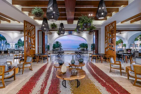 Lobby seating area with hanging lanterns and ocean view at Hilton Los Cabos.