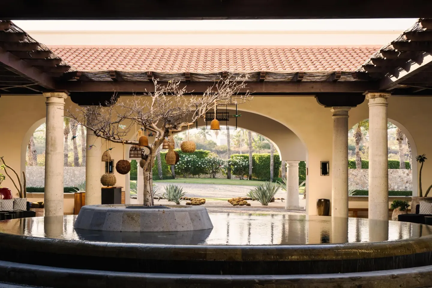 Open-air lobby water feature with arches and columns at Hilton Los Cabos.