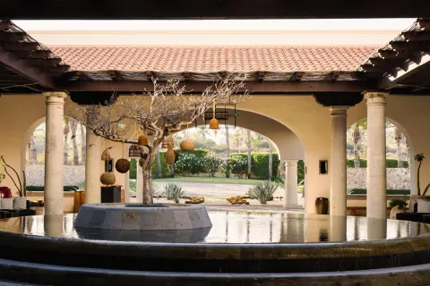 Open-air lobby water feature with arches and columns at Hilton Los Cabos.