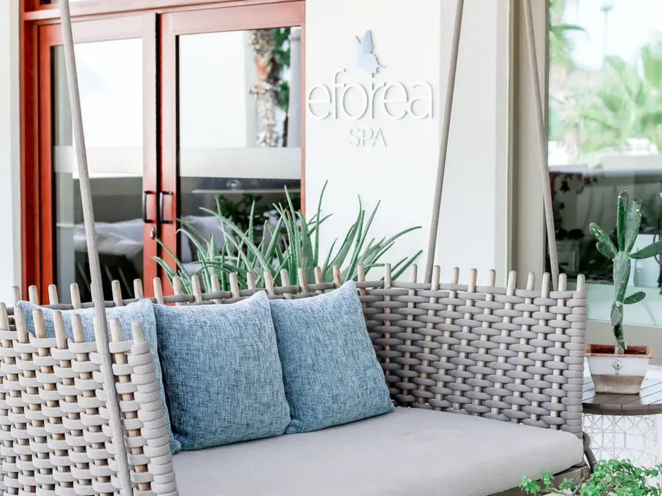 Spa lounge swing seating with blue pillows at Hilton Los Cabos.