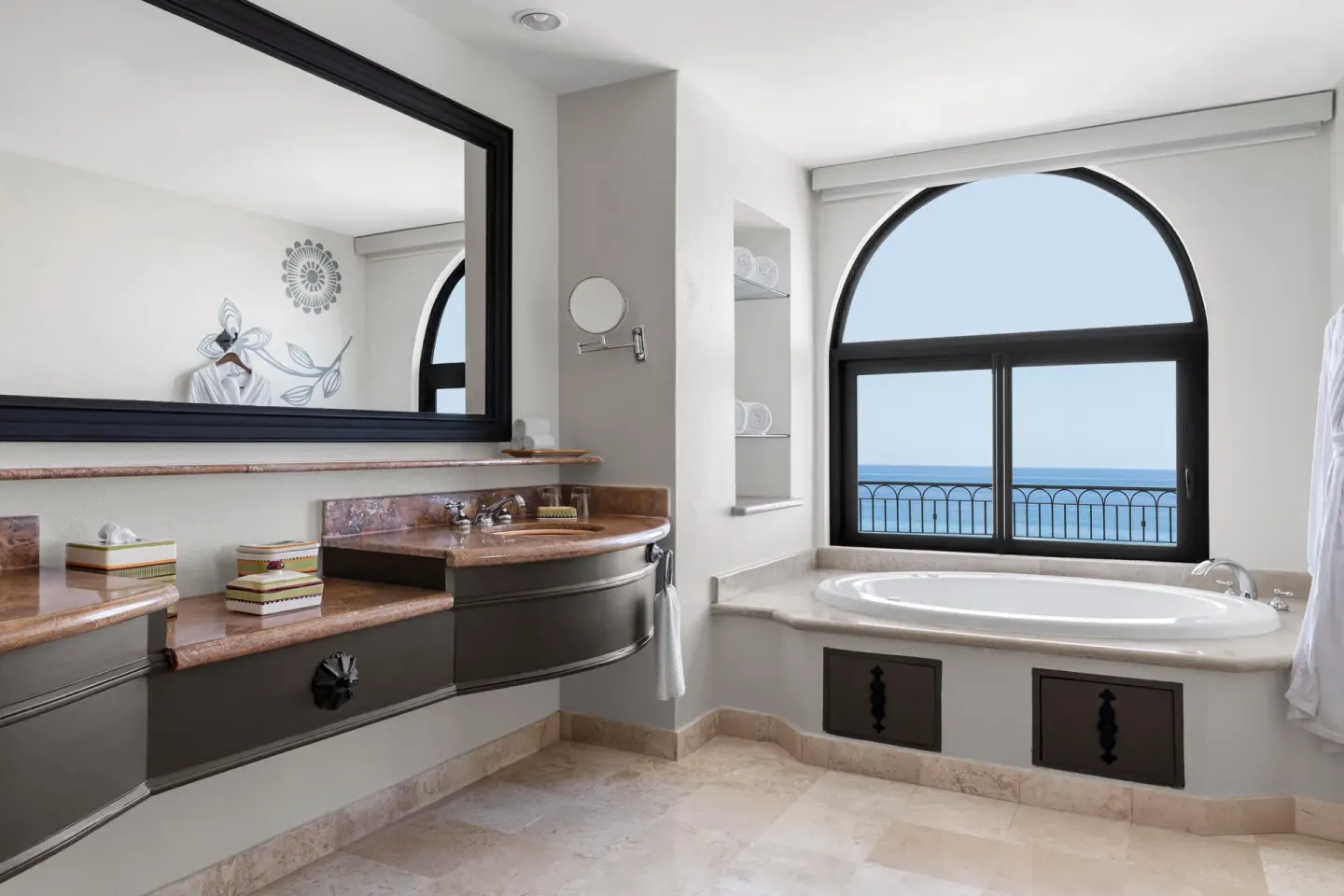 Altamar Governor Suite bathroom with tub, vanity, and ocean view at Hilton Los Cabos.