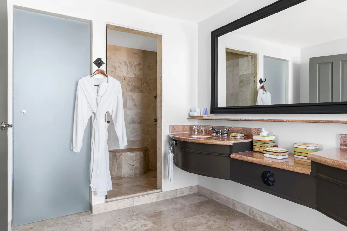 Altamar Governor Suite bathroom vanity and shower with robe at Hilton Los Cabos.