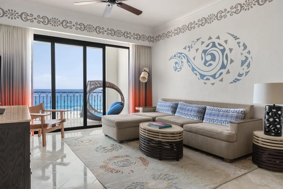 Altamar Governor Suite living room with sofa and ocean balcony at Hilton Los Cabos.