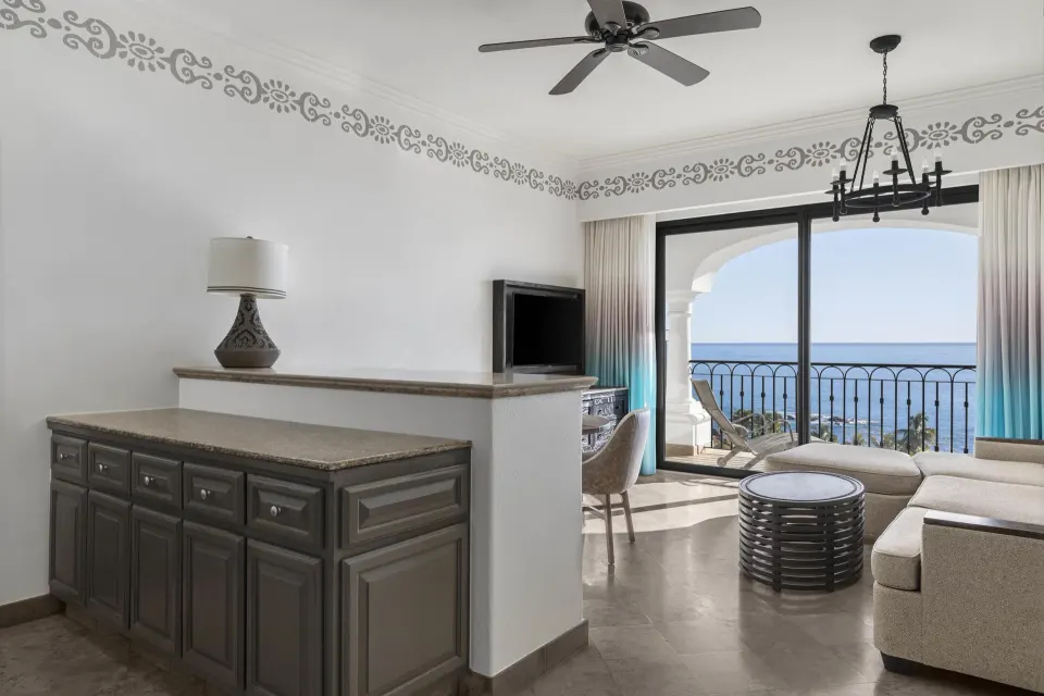 Altamar Premier Suite parlor at Hilton Los Cabos with sofa, balcony, and ocean view.