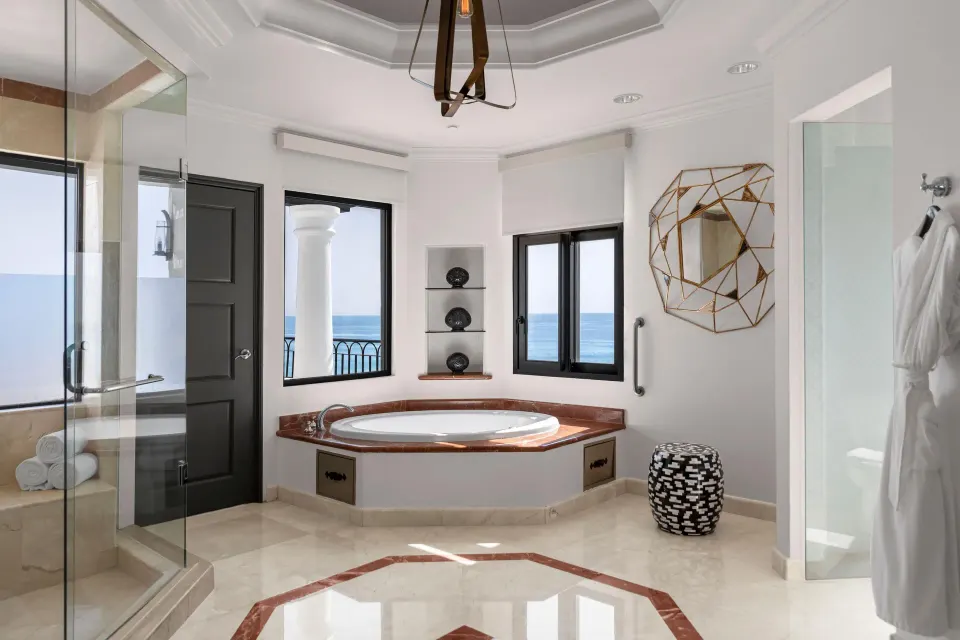 Bathroom in the Altamar Presidential Suite at Hilton Los Cabos with soaking tub and ocean-facing windows.