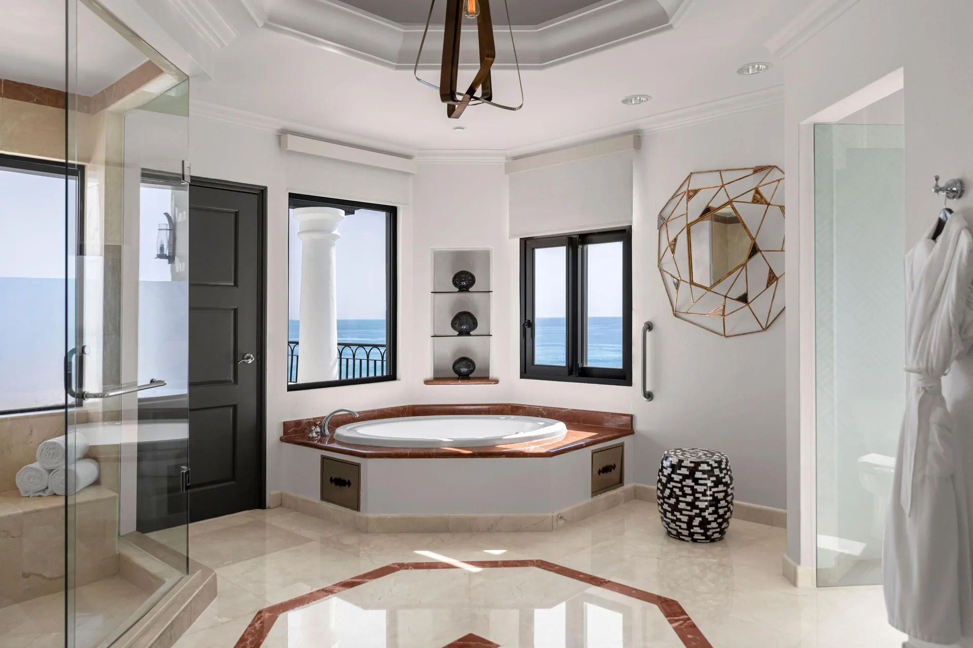 Bathroom in the Altamar Presidential Suite at Hilton Los Cabos with soaking tub and ocean-facing windows.