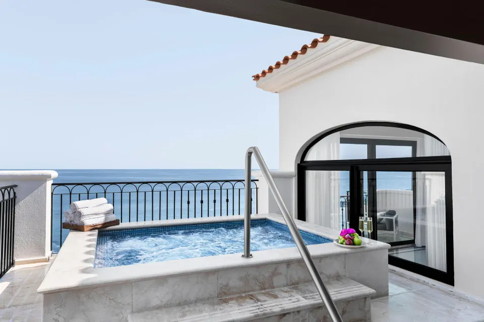 Private plunge pool on the Altamar Presidential Suite terrace at Hilton Los Cabos with ocean beyond.