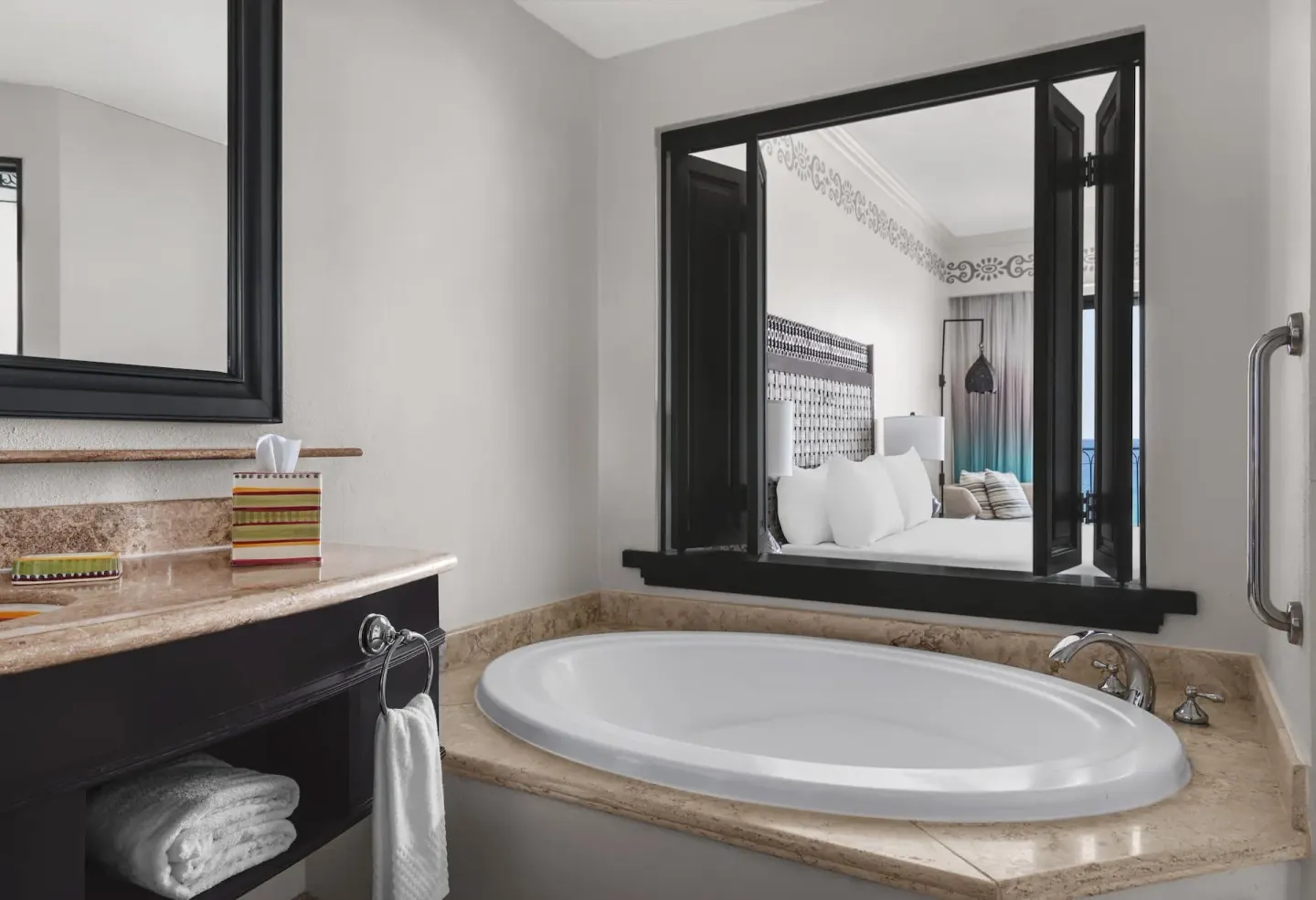Accessible bathroom soaking tub with pass-through view to the room at Hilton Los Cabos.