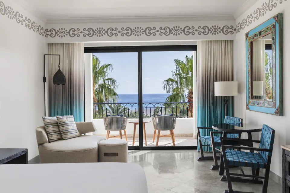 Accessible Deluxe Ocean View room sitting area with balcony view at Hilton Los Cabos.