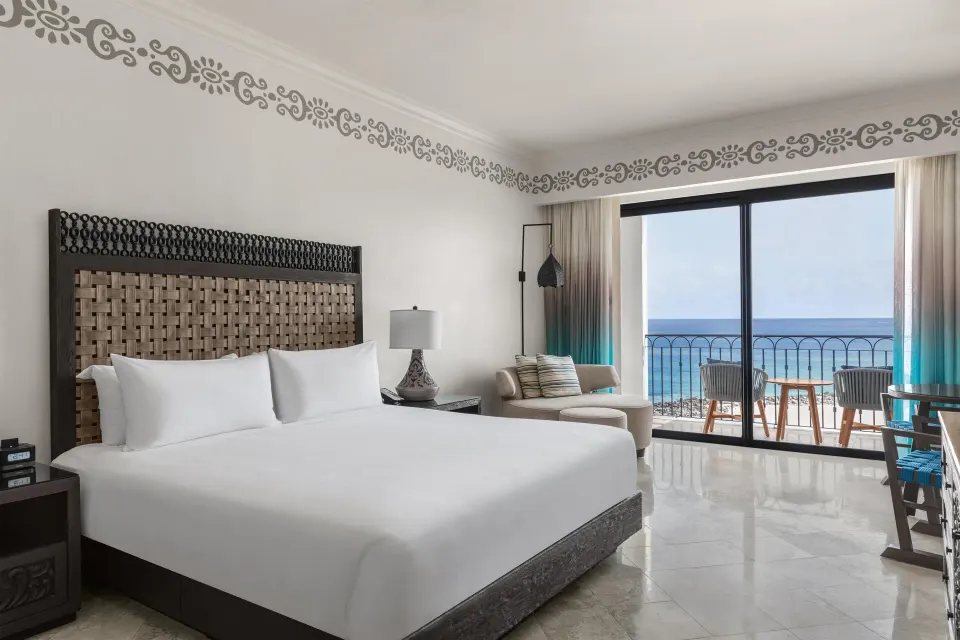 Deluxe oceanfront room with king bed and balcony view at Hilton Los Cabos.