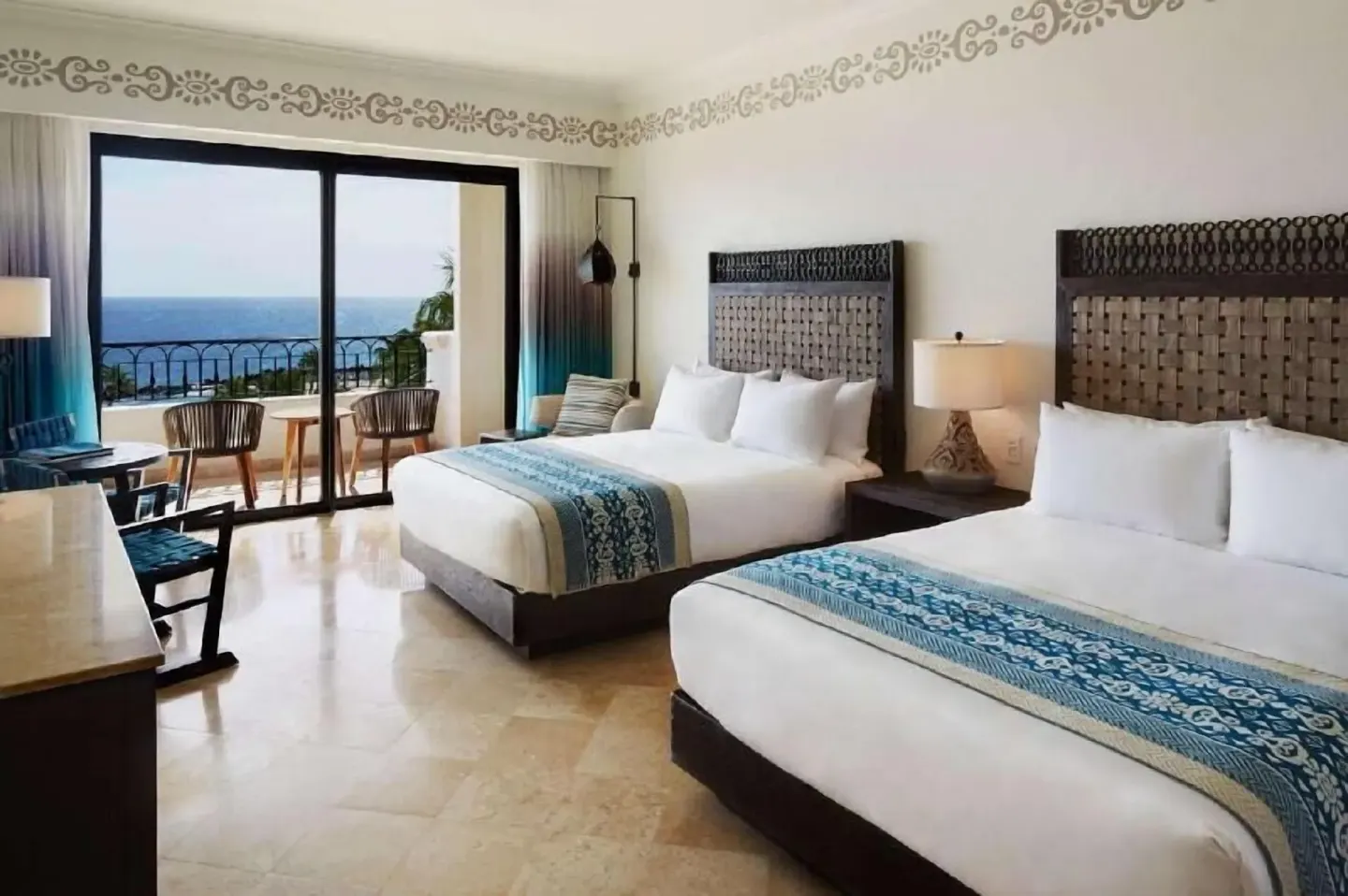 Deluxe Room Coastal Garden View two beds at Hilton Los Cabos with balcony and ocean view.