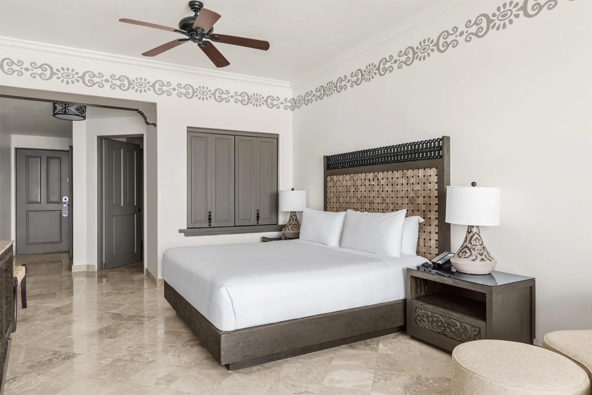 Deluxe Room Ocean View with king bed, nightstands, and ceiling fan at Hilton Los Cabos.