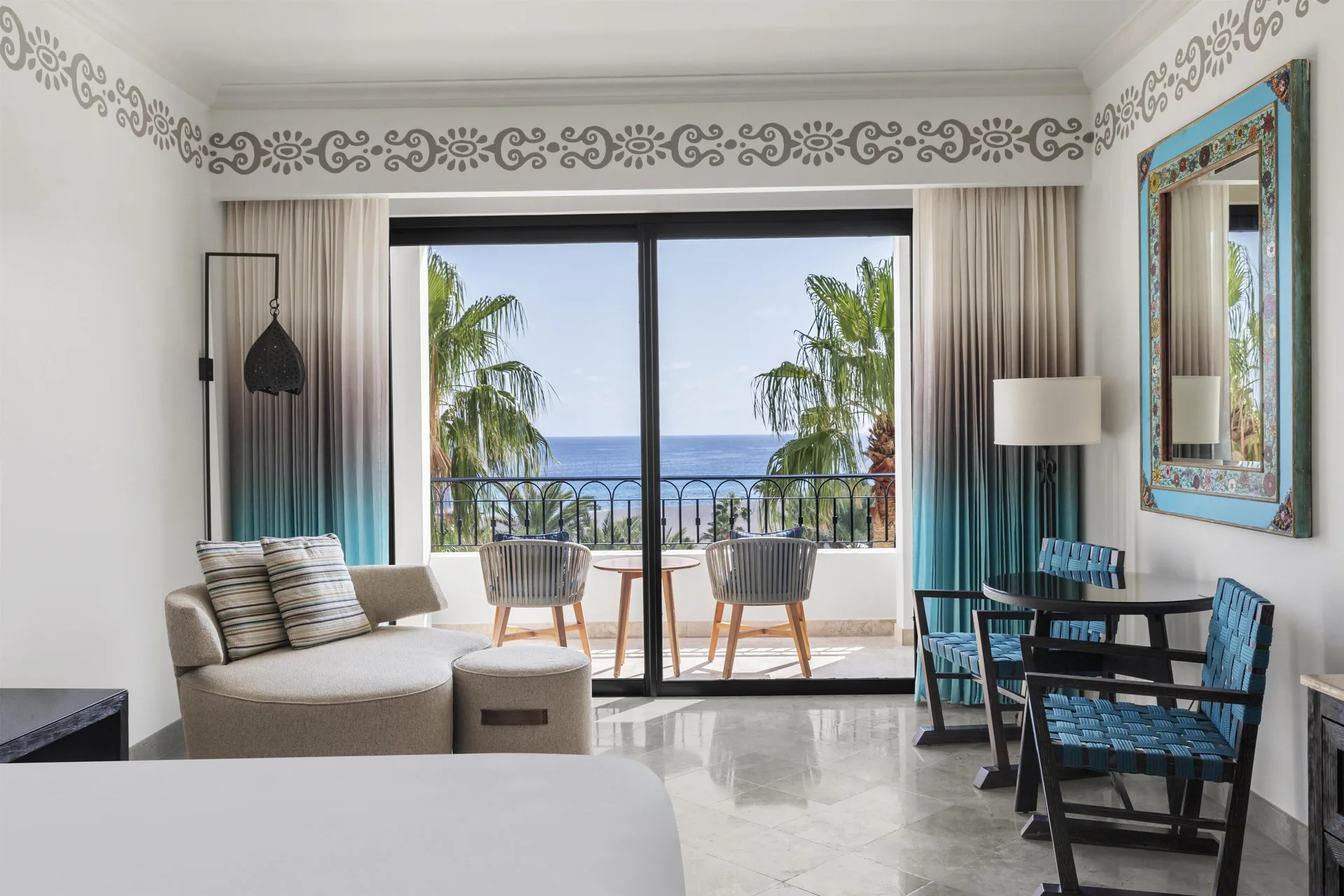 Deluxe Room Ocean View sitting area and balcony doors at Hilton Los Cabos.