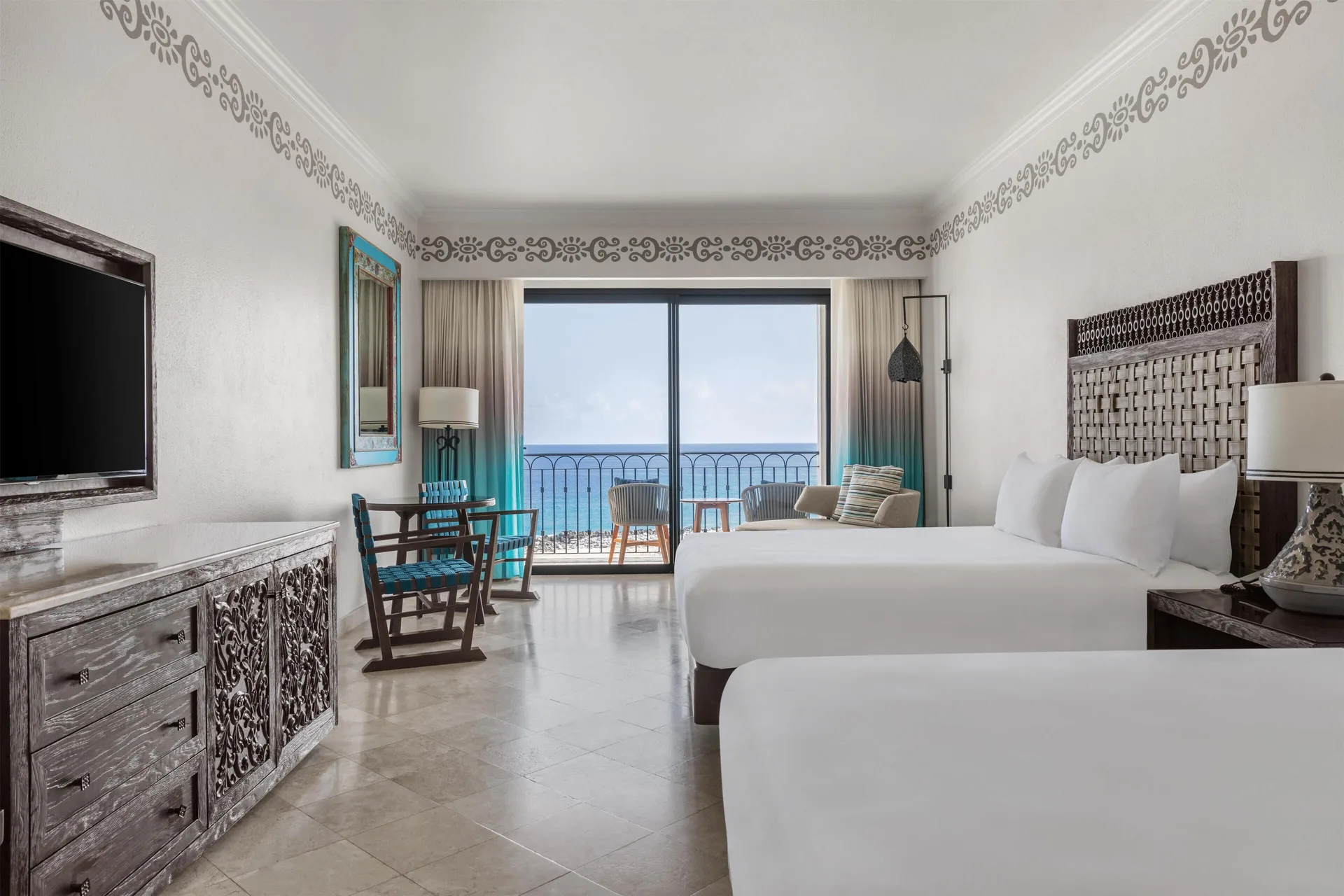 Deluxe oceanfront room with two beds and balcony view at Hilton Los Cabos.