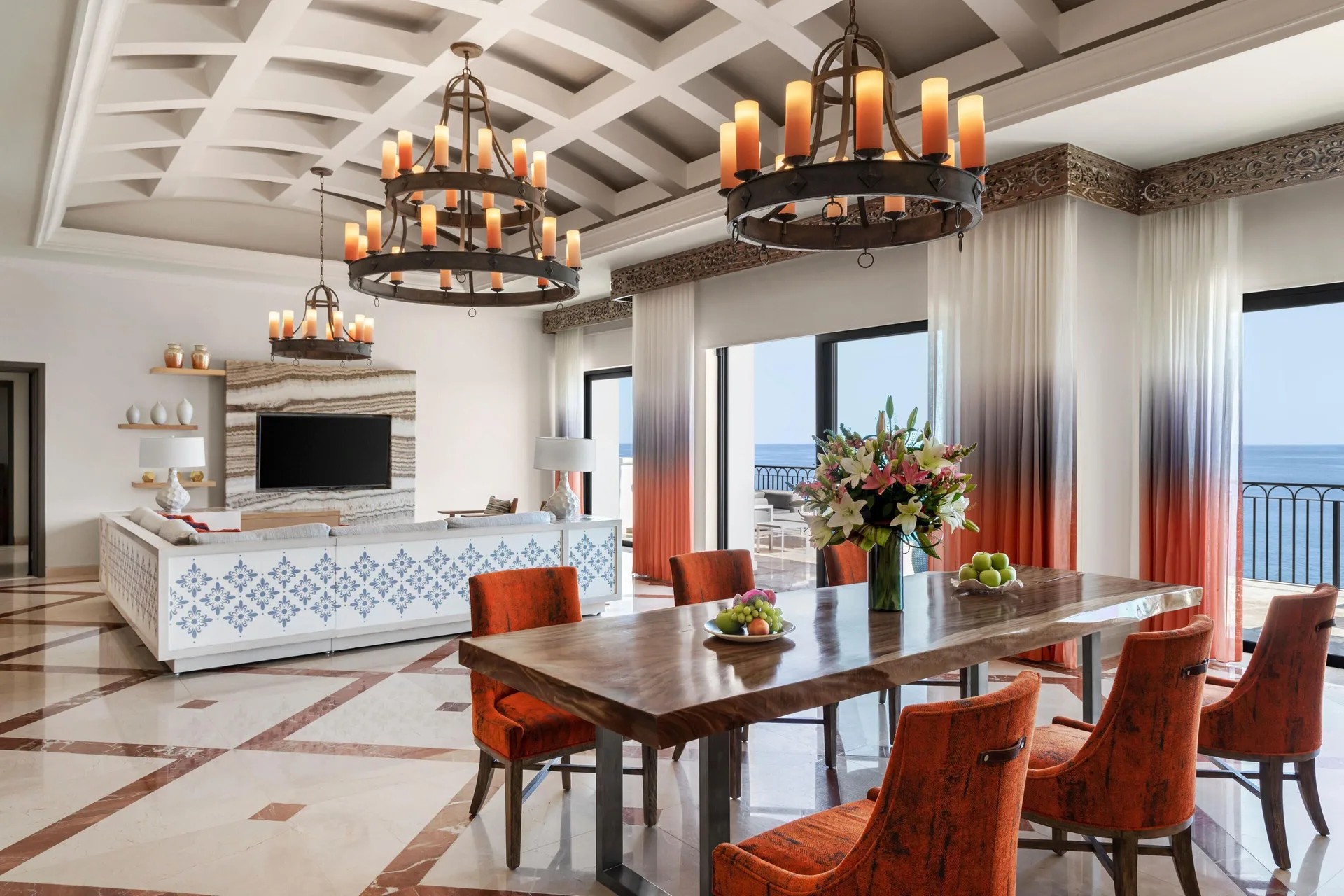Presidential Suite dining and living room at Hilton Los Cabos with oceanfront windows.