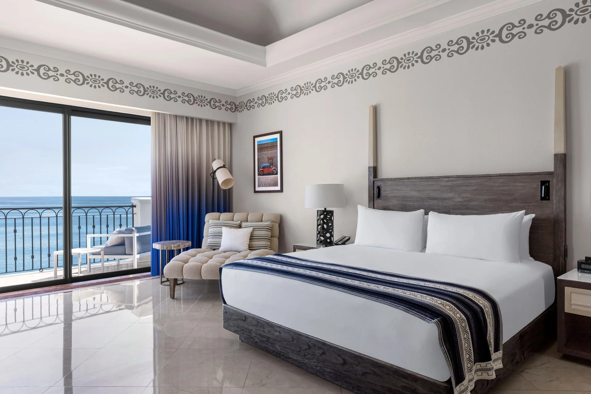 Oceanfront king bedroom in the Presidential Suite at Hilton Los Cabos with balcony seating.