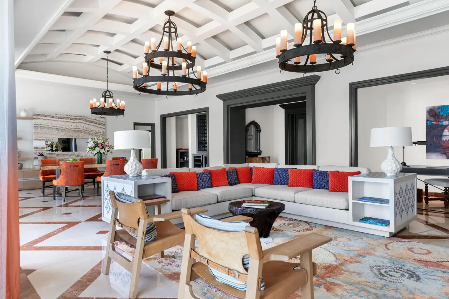 Presidential Suite living room at Hilton Los Cabos with sectional seating and chandeliers.