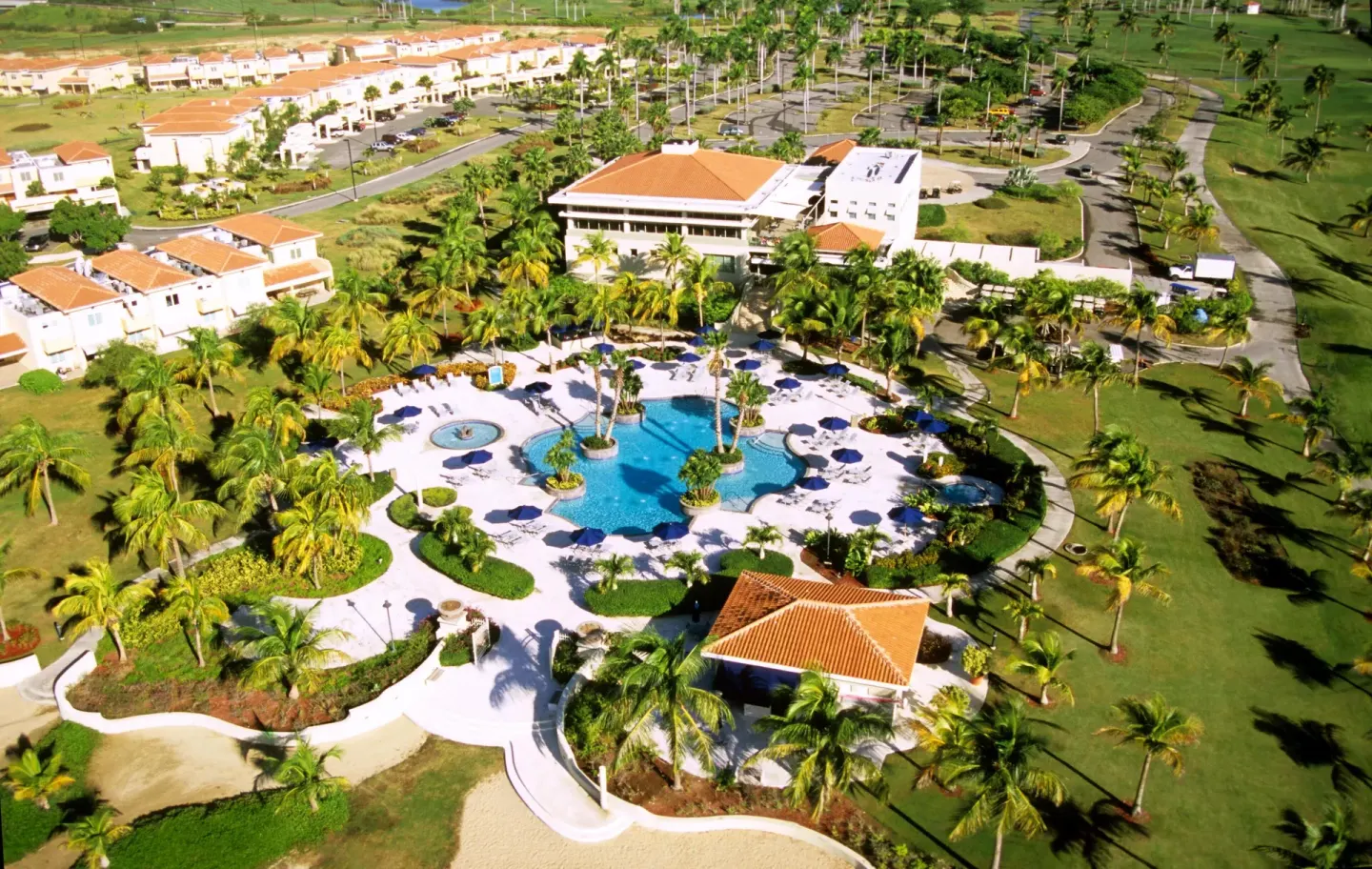 Aerial view of the pool, grounds, and golf course at Hilton Ponce Golf & Casino Resort.