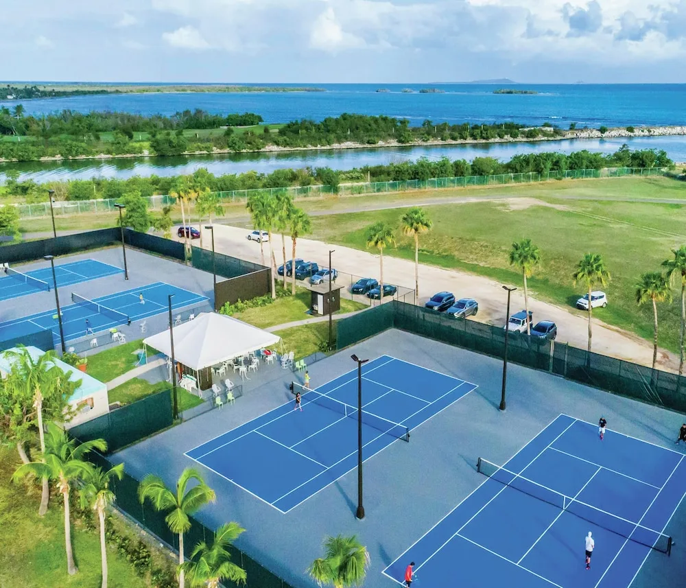Coastal tennis courts and water views at Hilton Ponce Golf & Casino Resort.