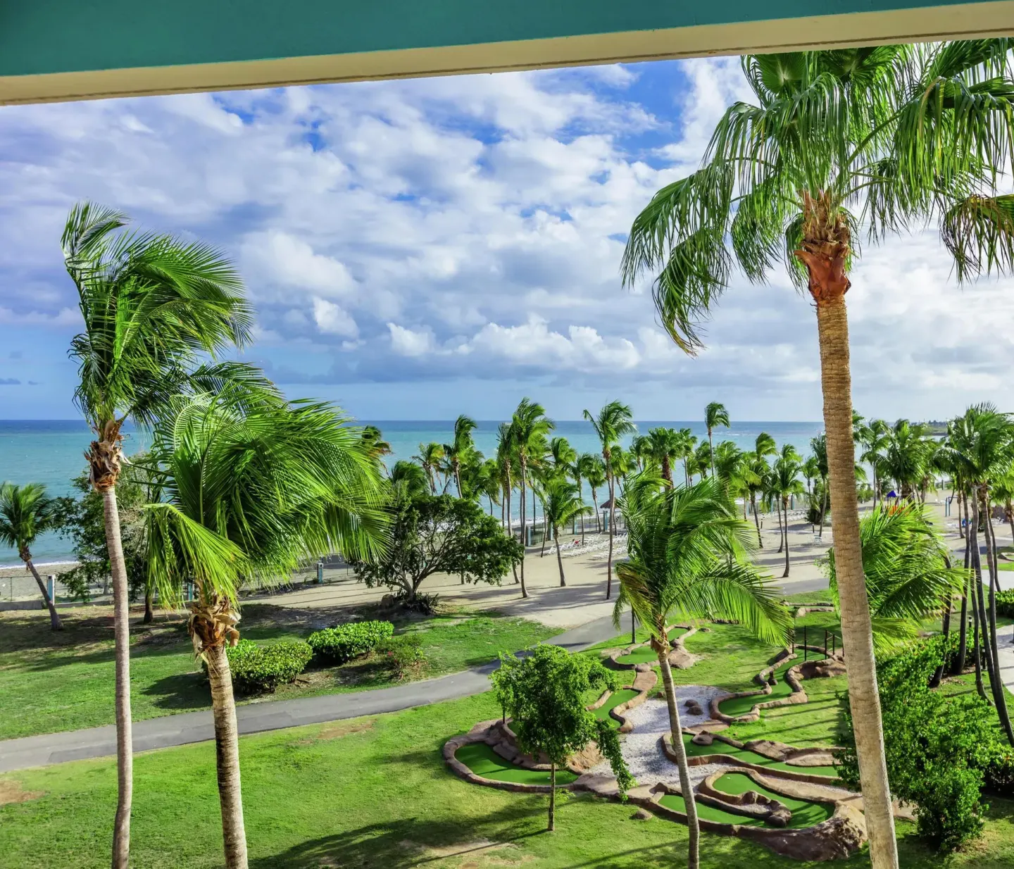 Ocean and palm view with mini golf course at Hilton Ponce Golf & Casino Resort.