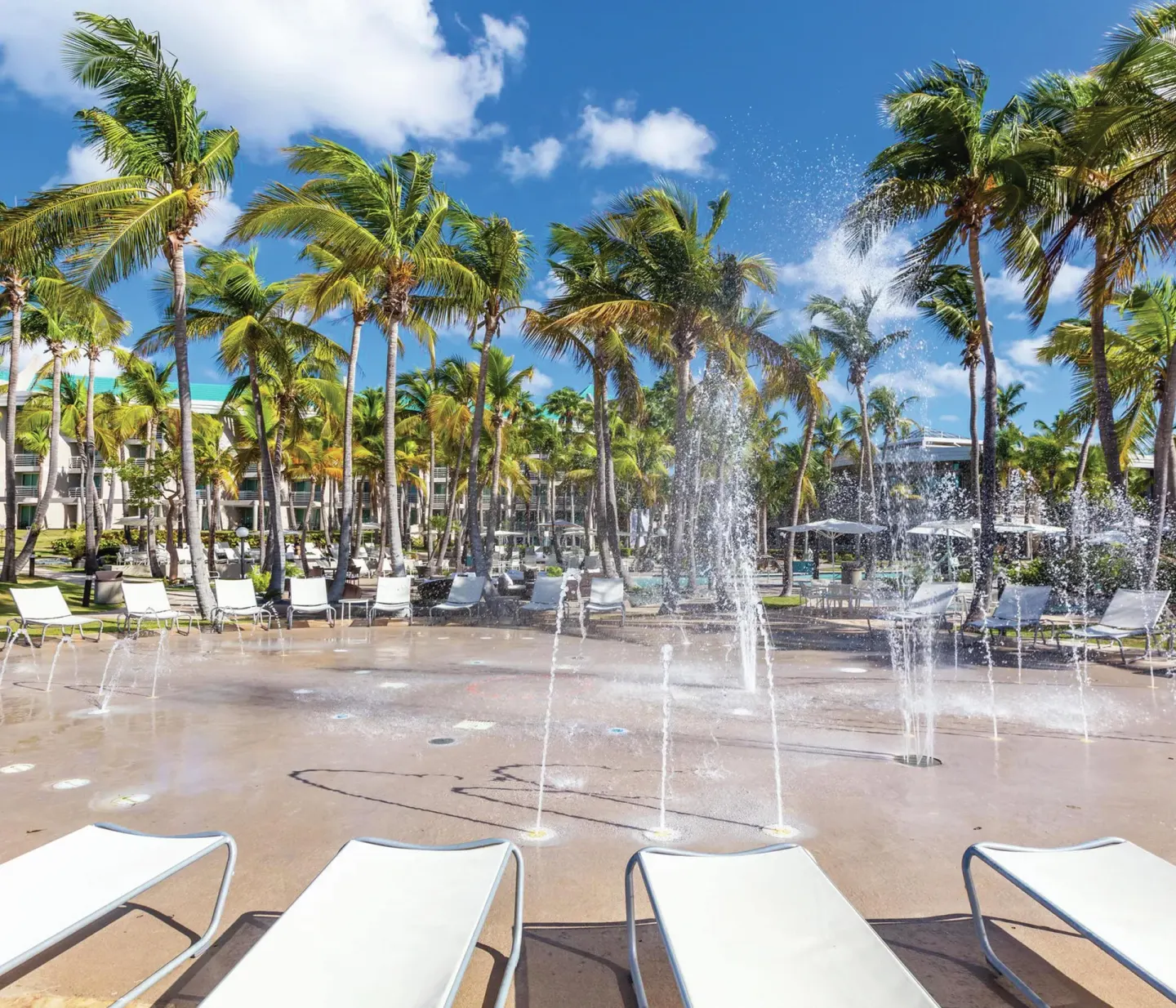 Splash pad with water jets and lounge chairs at Hilton Ponce Golf & Casino Resort.
