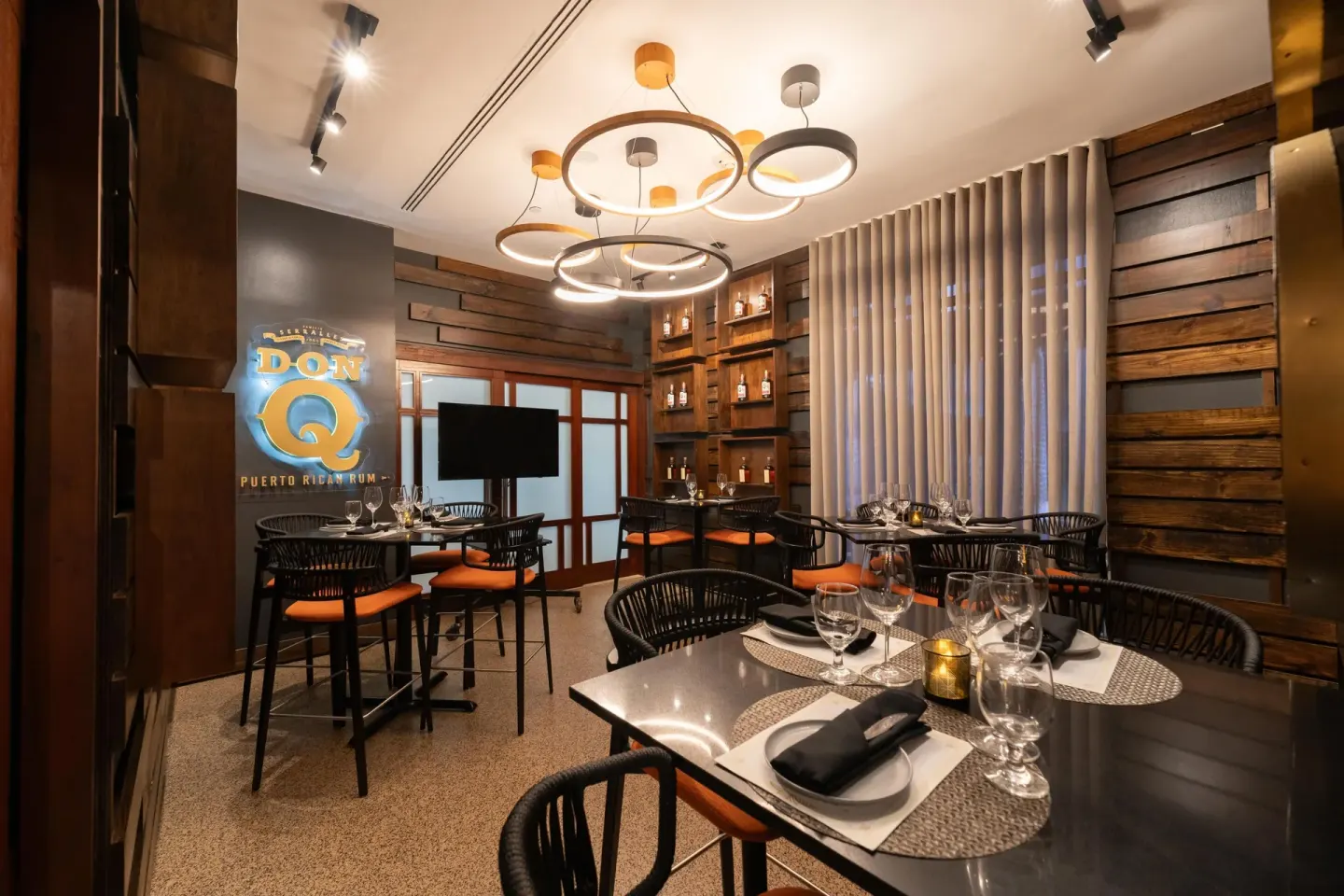 Private dining room with rum display and set tables at Hilton Ponce Golf & Casino Resort.