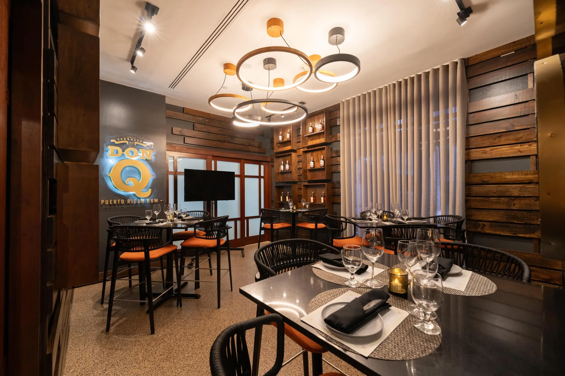 Private dining room with rum display and set tables at Hilton Ponce Golf & Casino Resort.