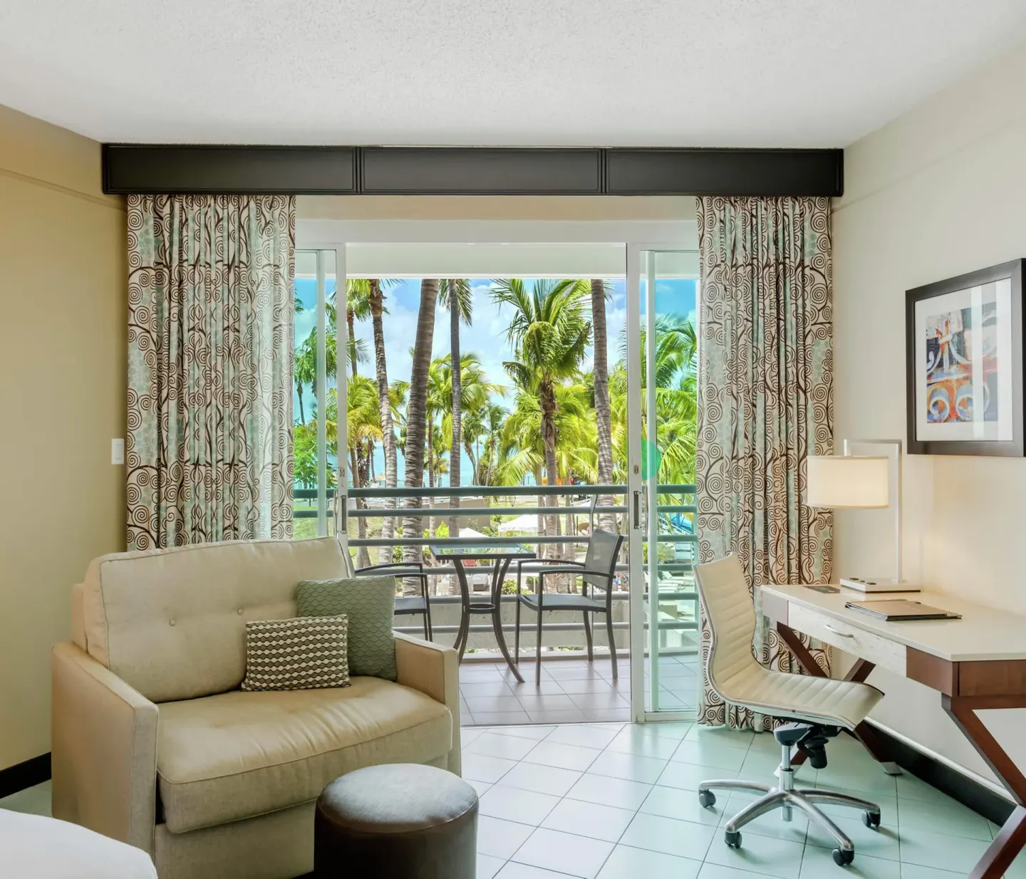 Pool view room sitting area and balcony at Hilton Ponce Golf & Casino Resort.