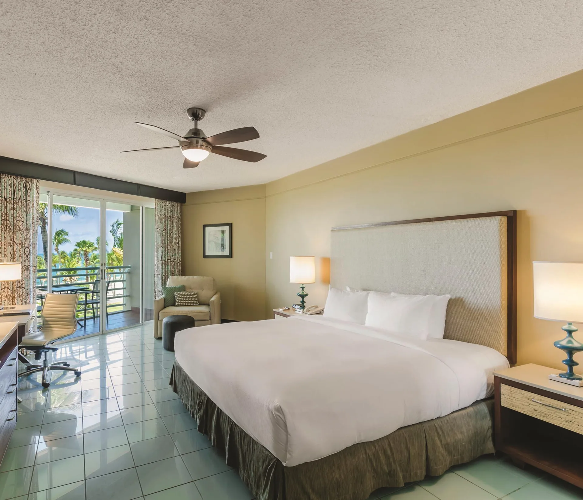 King bed room with balcony pool view at Hilton Ponce Golf & Casino Resort.