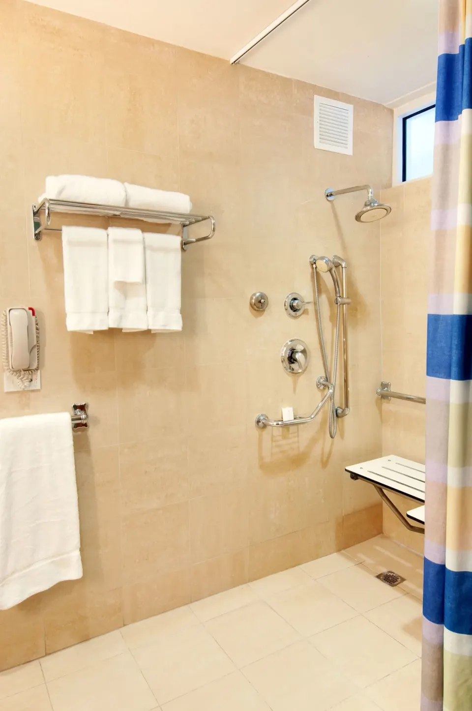 Accessible roll-in shower with grab bars at Hilton Ponce Golf & Casino Resort.