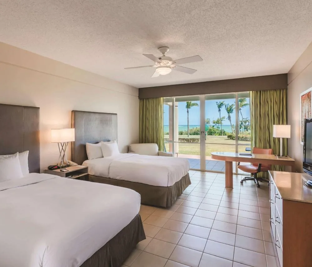 Oceanfront double-bed patio room with ocean view at Hilton Ponce Golf & Casino Resort.