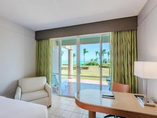 Oceanfront deluxe patio room sitting area at Hilton Ponce Golf & Casino Resort.