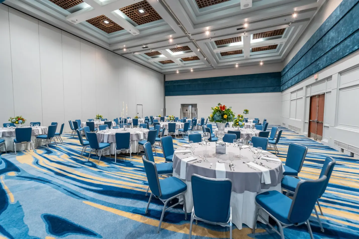 Ballroom set for a banquet with round tables at Hilton Ponce Golf & Casino Resort.