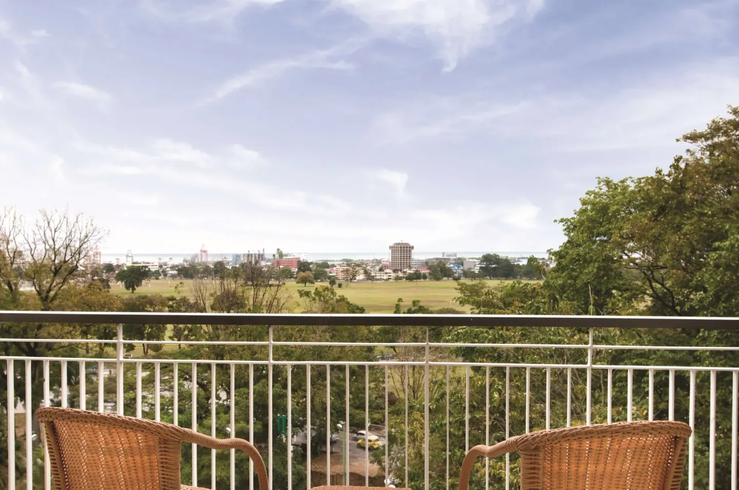 Balcony chairs overlook Port of Spain from Hilton Trinidad & Conference Centre.