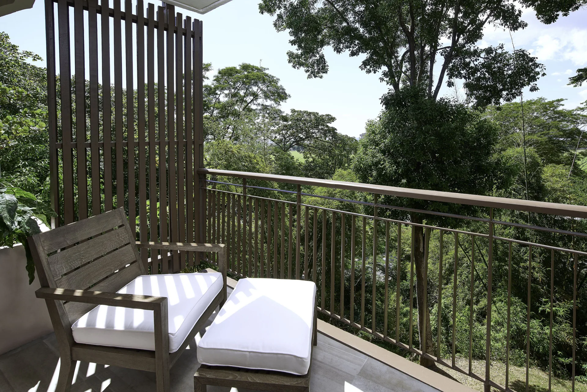 Presidential Suite 2 Balconies balcony seating with garden views at Hilton Trinidad and Conference Centre overlooking Port of Spain.