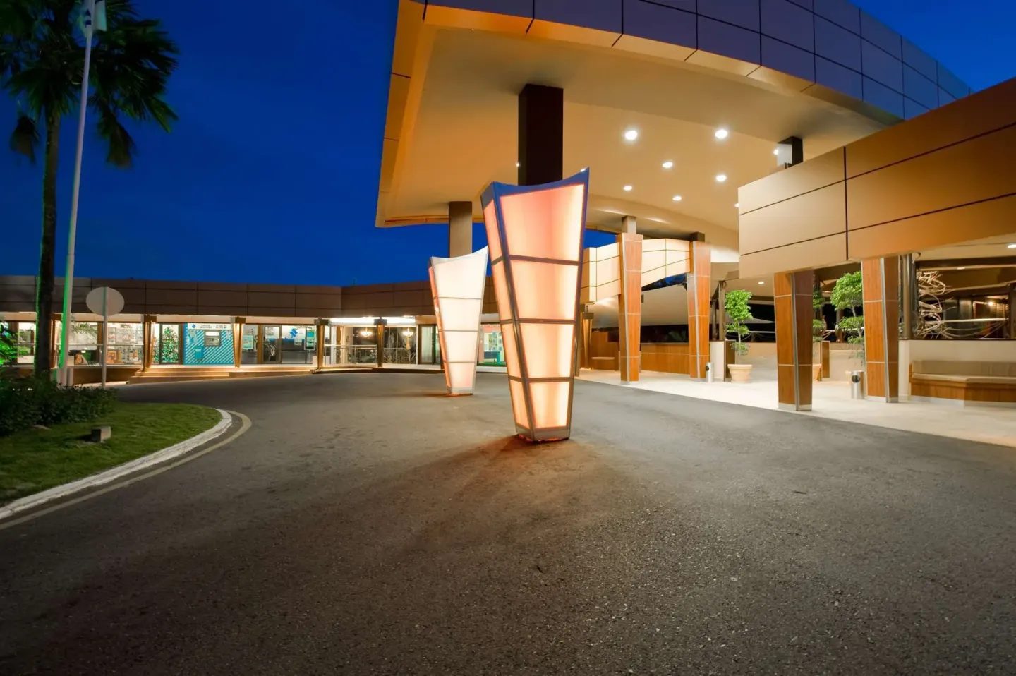 Covered entrance with glowing light sculptures at Hilton Trinidad & Conference Centre.