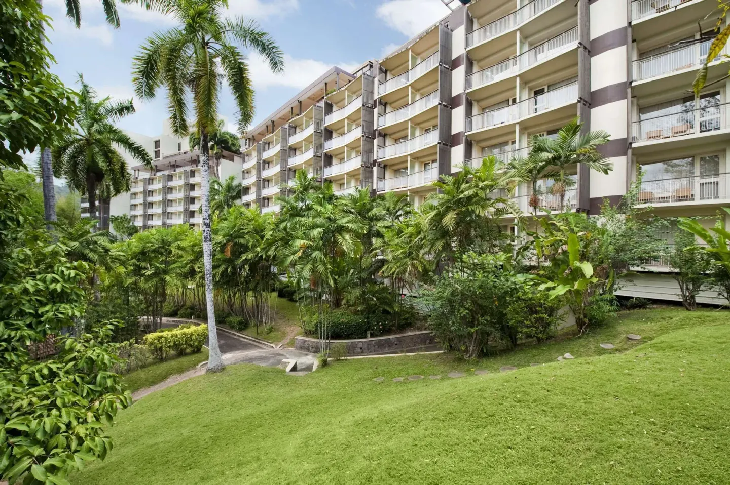 Hotel exterior balconies and tropical gardens at Hilton Trinidad & Conference Centre.