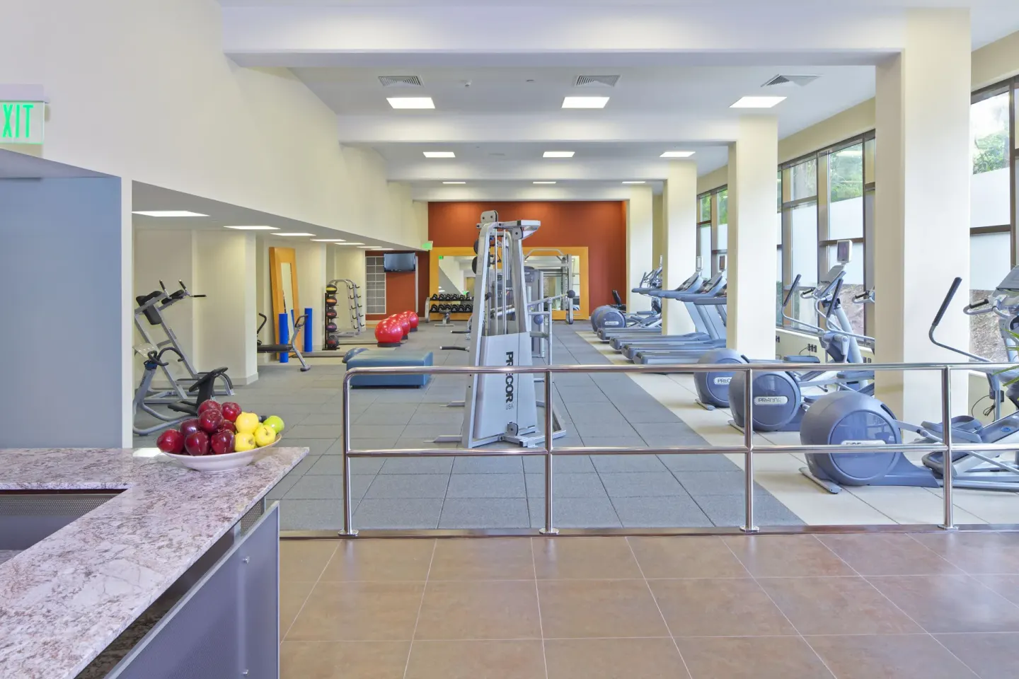 Fitness center with cardio machines and weights at Hilton Trinidad & Conference Centre.