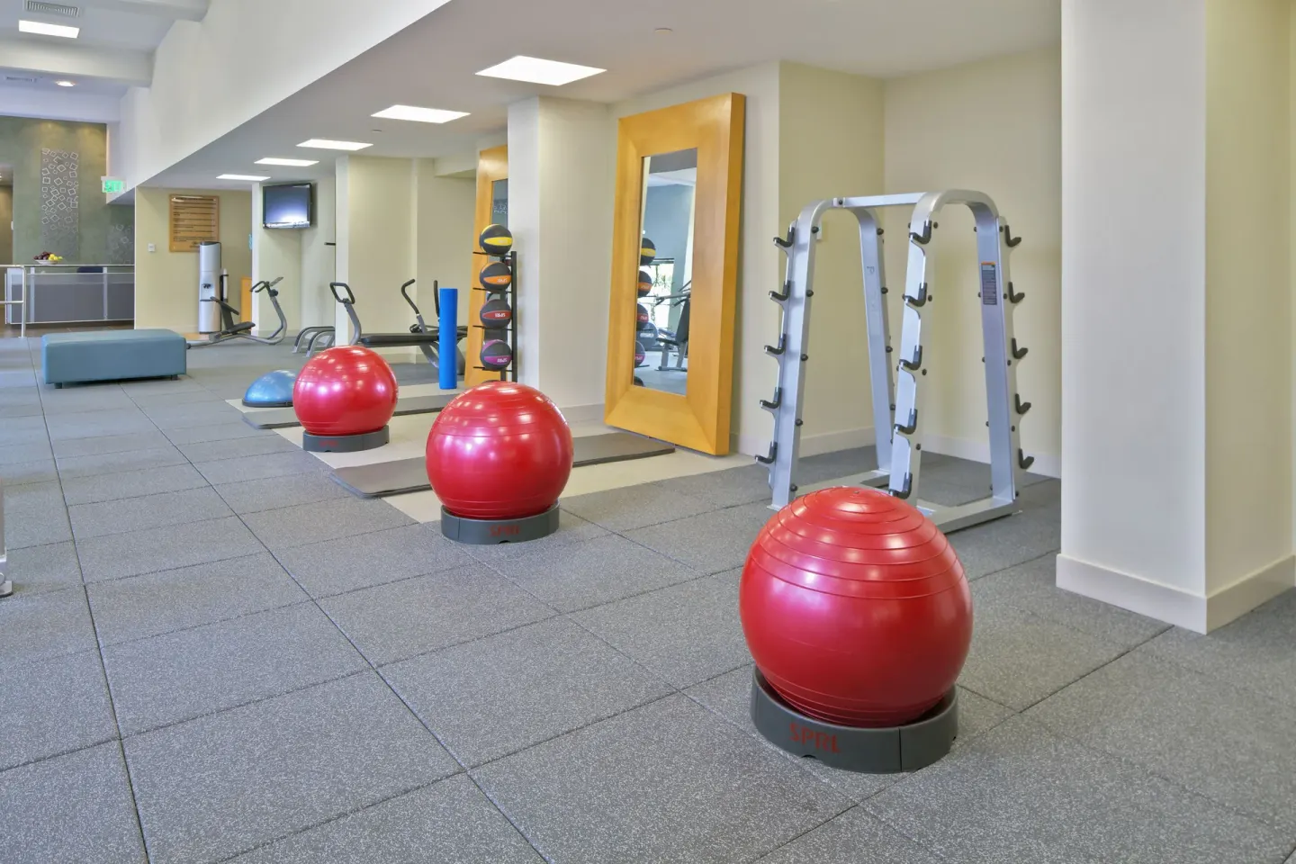 Fitness area with exercise balls and mirrors at Hilton Trinidad & Conference Centre.