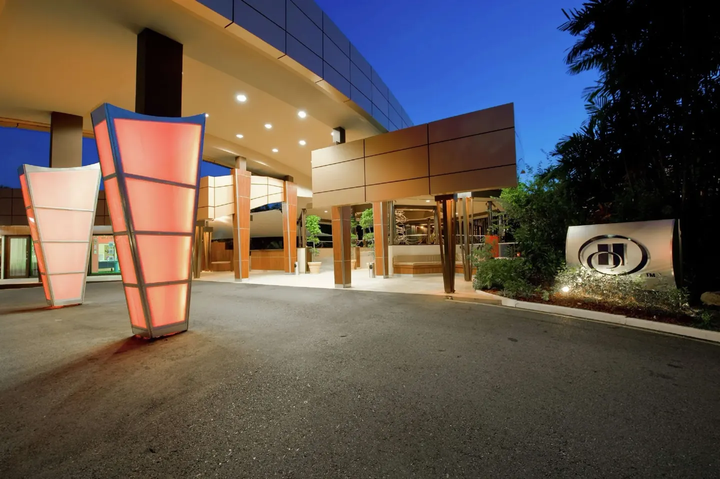 Illuminated hotel entrance and porte cochere at Hilton Trinidad & Conference Centre.